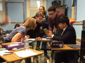Chinese exchange student, Daniel, shows WMS Journalism students how to write in Chinese characters.