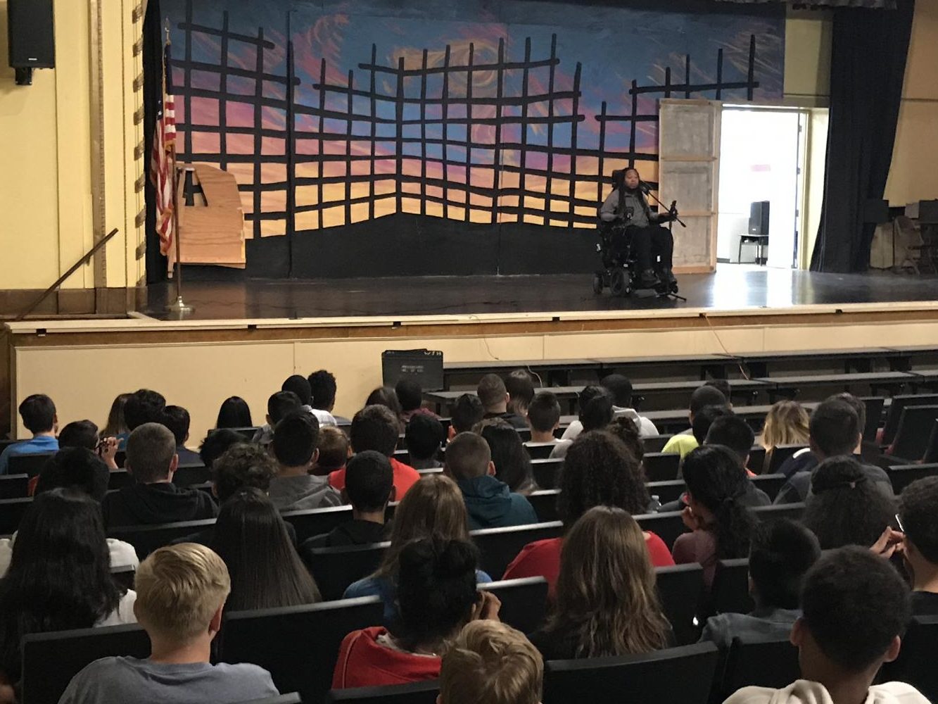 Eric LeGrand speaking to eighth graders about his life story 