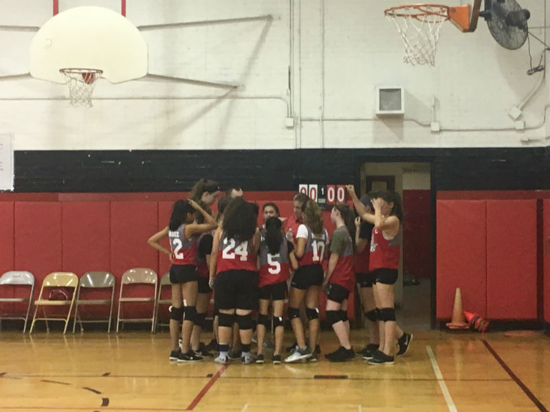 TEAMWORK MAKES THE DREAM WORK: The WMS Lady Warriors Volleyball Team huddle together to discuss what needs to be done at the game.