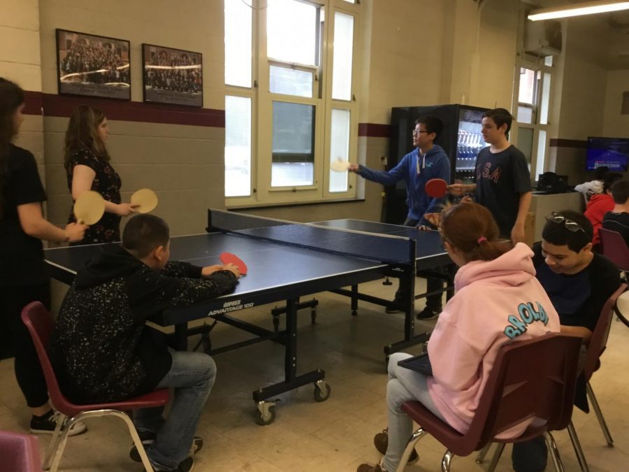 8th graders play ping pong during their gym.