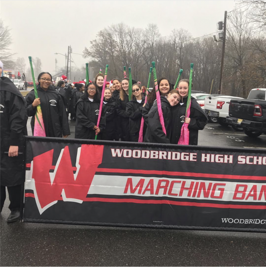 Woodbridge High-schoolers and middle schoolers in marching band smile for the camera.