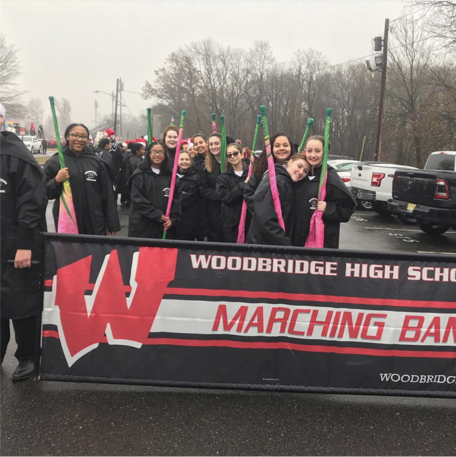 Woodbridge+High-schoolers+and+middle+schoolers+in+marching+band+smile+for+the+camera.