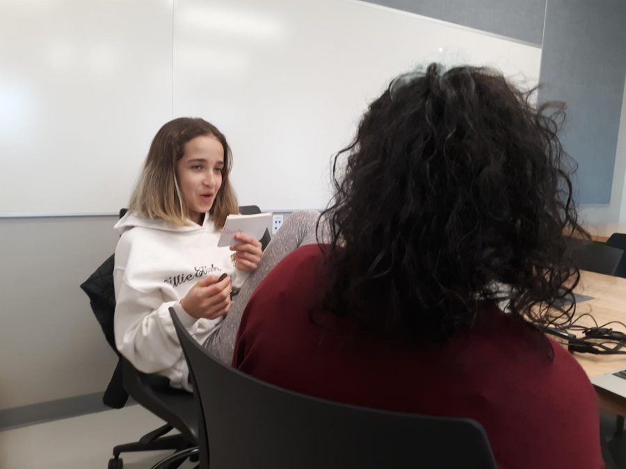 Kenza Kharbouche  and Candace Pinto are sitting at a table, helping each other study for a vocabulary test. They are working in partners 