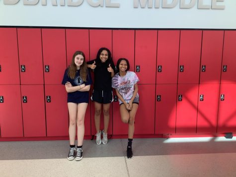 INTRODUCTION TO PEER LEADERS: Ciara, Nashly, and Taylor pose for a picture in front of the school. 