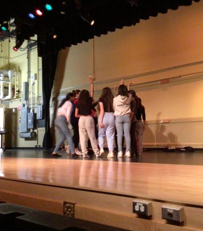 TEAMWORK MAKES THE DREAM WORK: The students of the WMS dance class huddle up before performing their dance.
