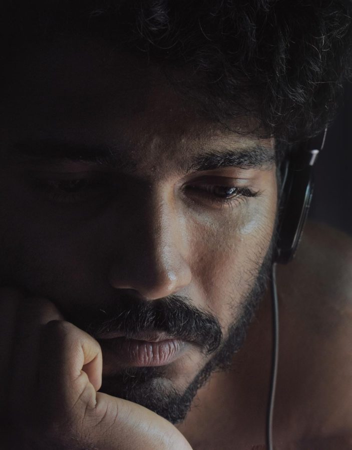 Photo via: https://www.pexels.com/photo/close-up-photo-of-man-looking-sad-while-wearing-black-headphones-4205610/ under the Creative Commons license