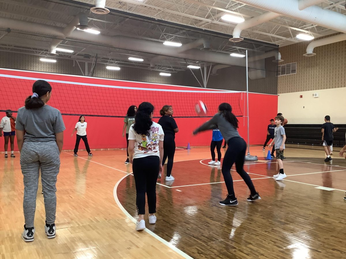 WMS students play an intense game of gym volleyball.
