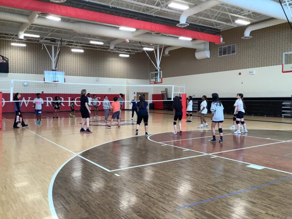 Students play volleyball during open gym. 