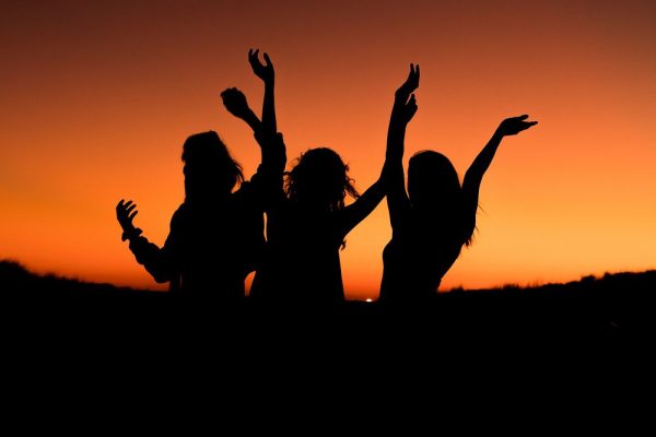 Silhouette of a group of friends celebrating in an orange sunset. 
Photo fromhttps://www.rawpixel.com/search/friends%20silhouette?page=1&path=_topics&sort=curated 
Under Creative Common License  