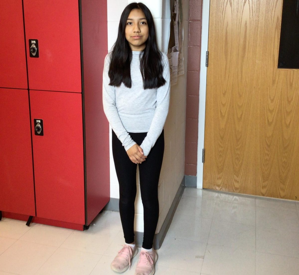 Nathaly poses for a picture in the hallway.