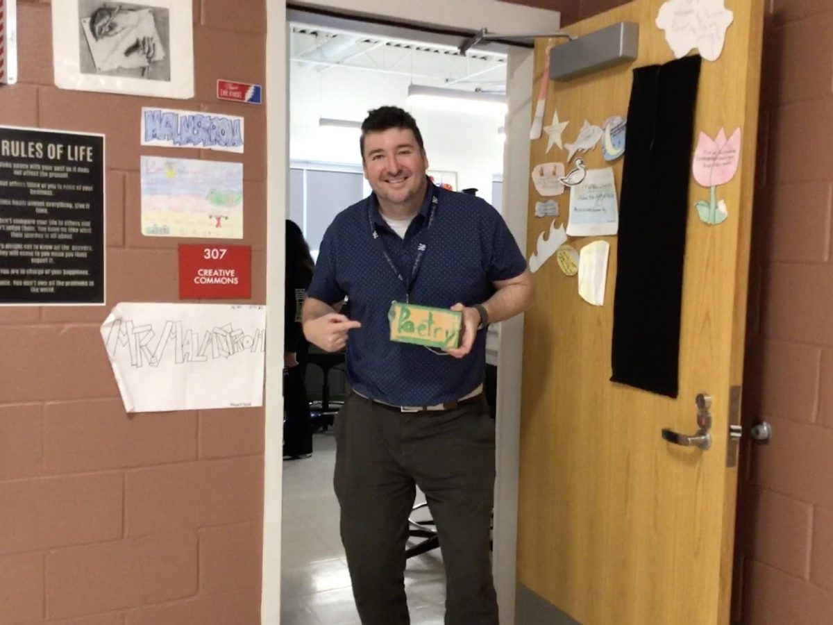 Mr.Malmstrom poses with a poetry painting.
