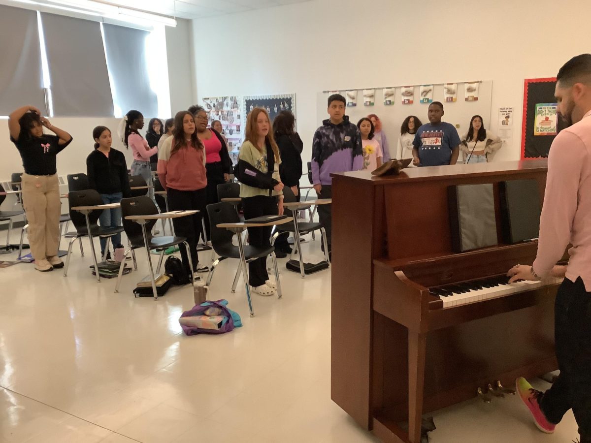 Mr.McGuire teaches his chorus students.