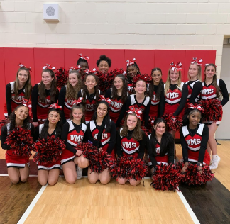 The WMS cheer team poses after a win in the 2023-2024 season. 