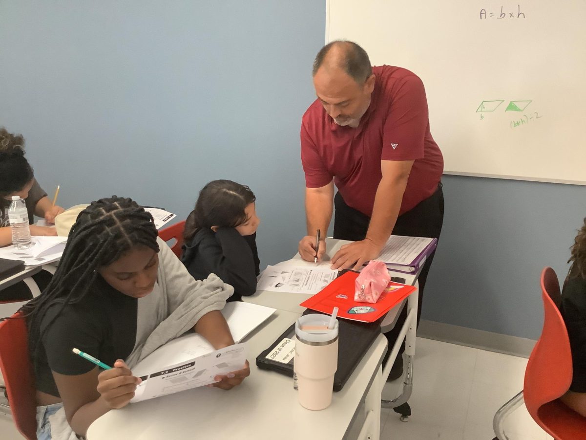 Mr. Cianfano helps a 6th grader with her work in the first quarter.