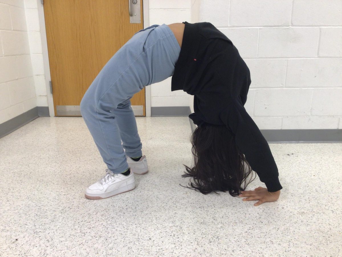 7th Grader Analy Castro does a backbend for a picture.