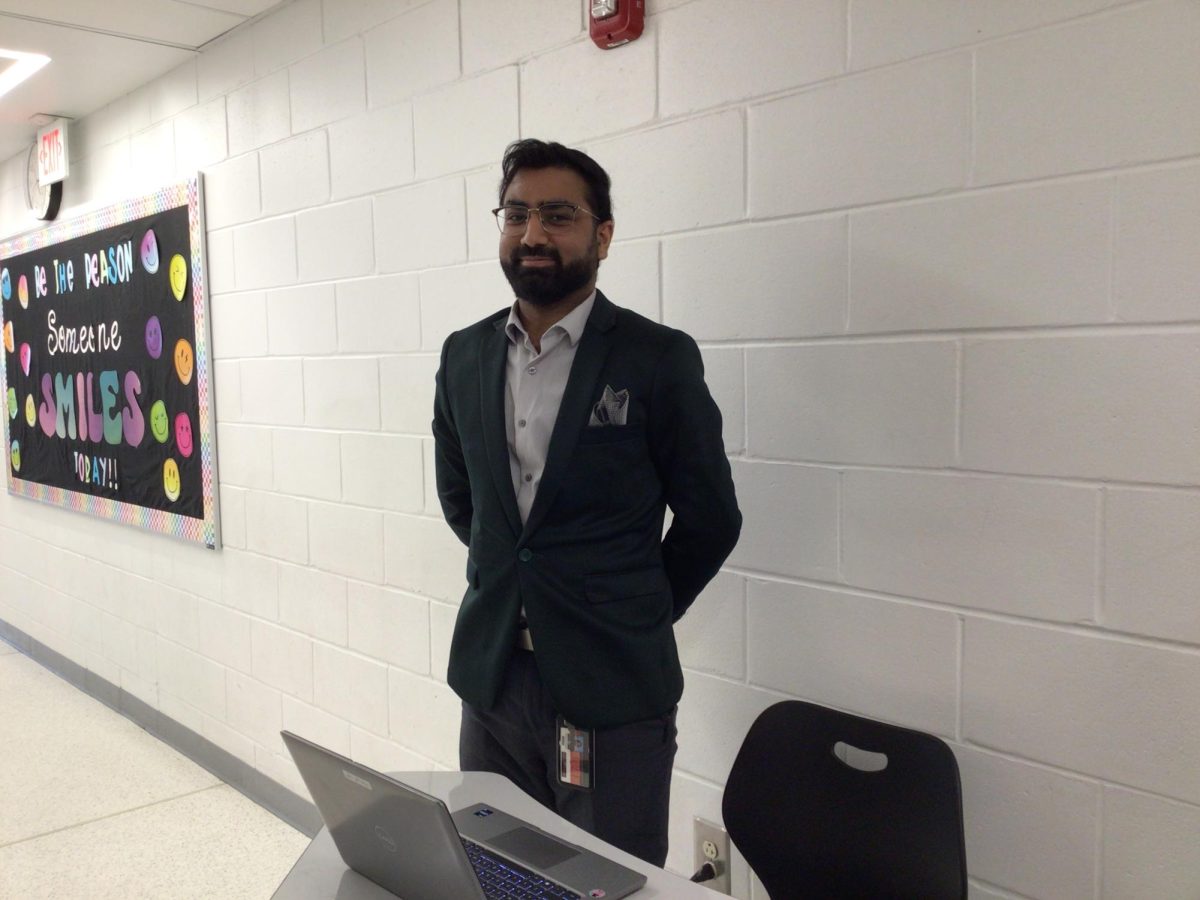 Mr. Ahmed poses for a photo on a Tuesday afternoon while doing bathroom duty.
