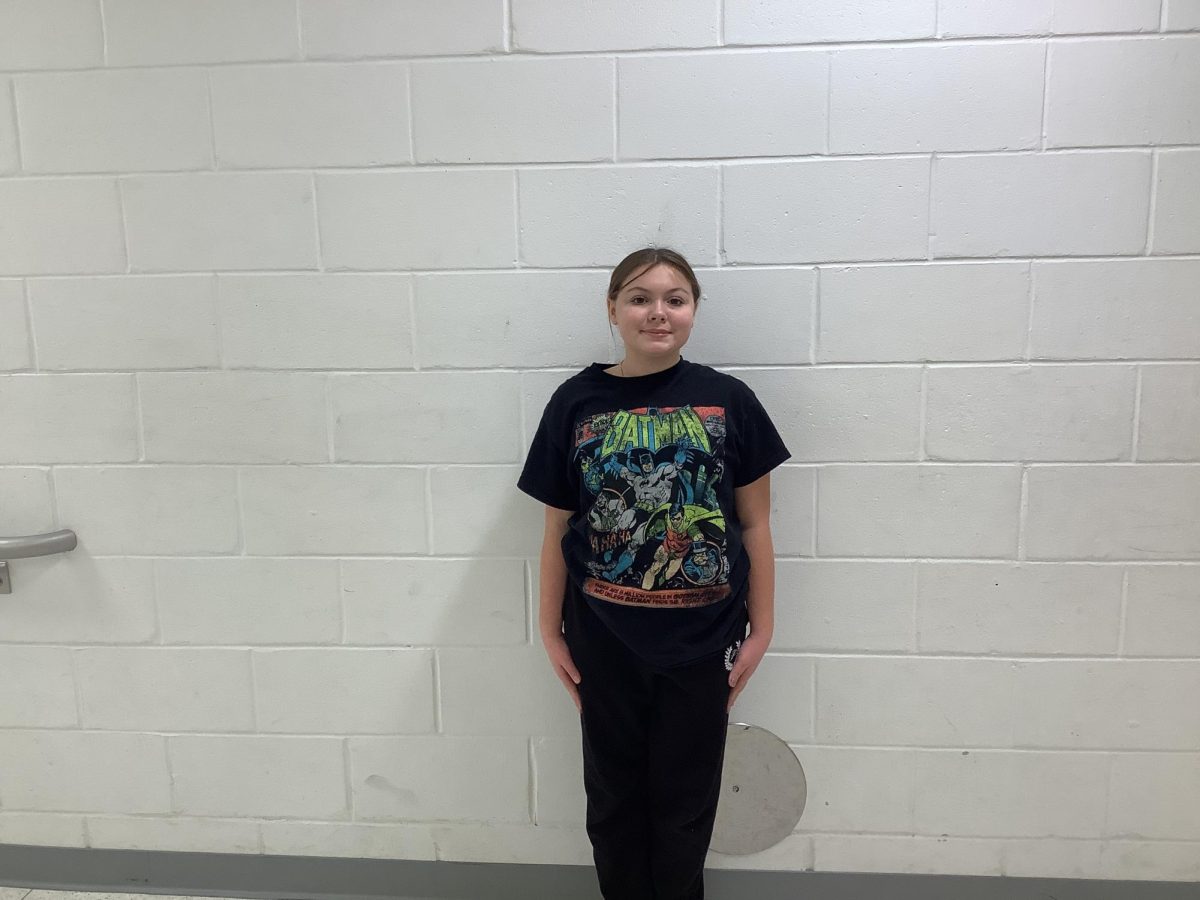 Nina Bragg poses for a picture outside the gym room in 4th period.