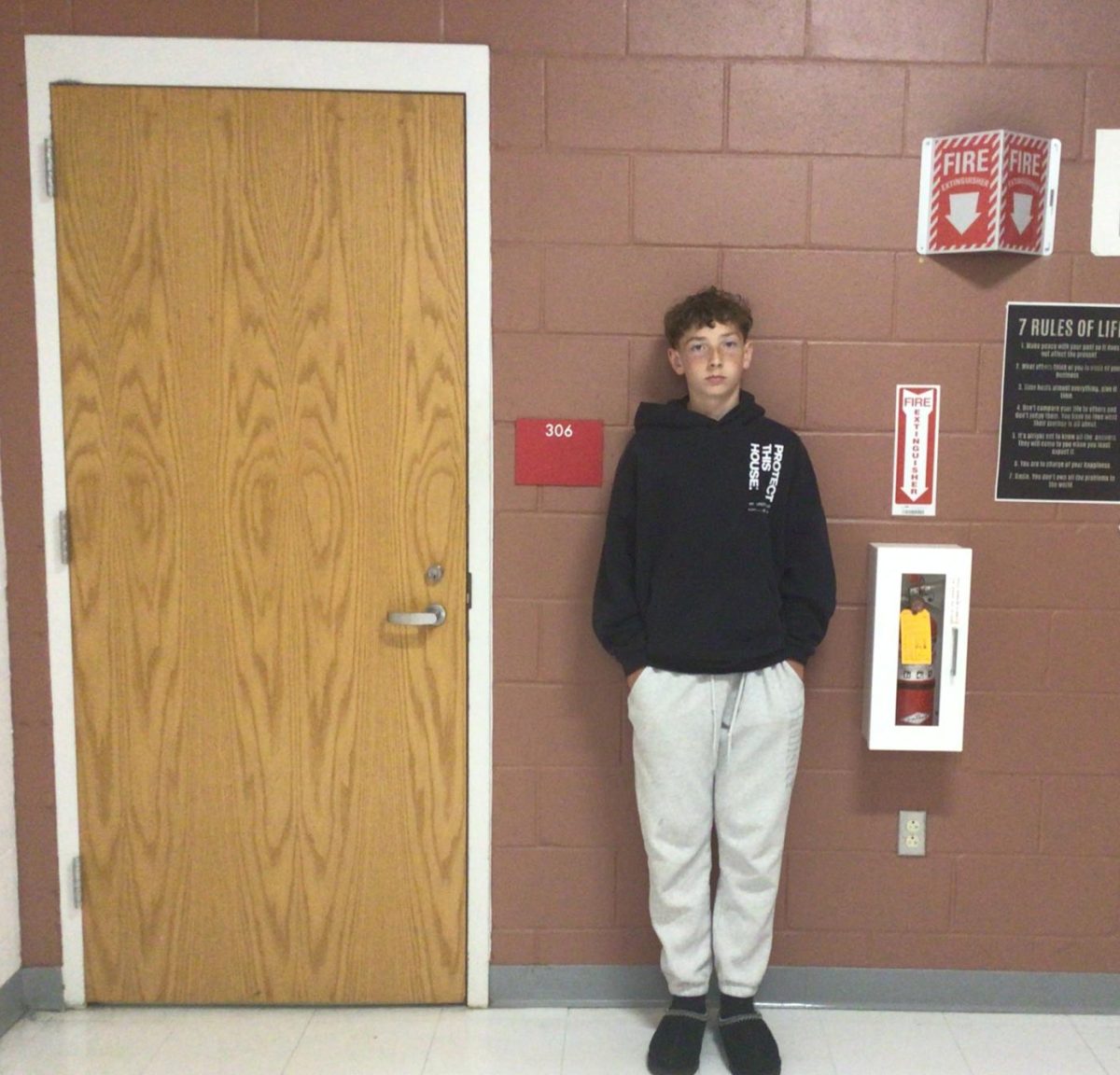 Daniel Crowley poses for photo in front of room 307