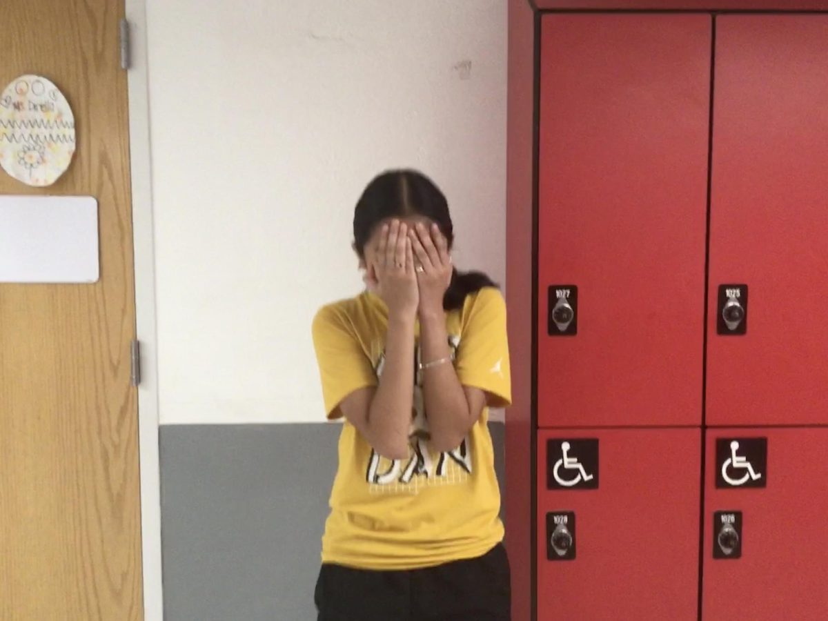 Yamileth poses next to the lockers 