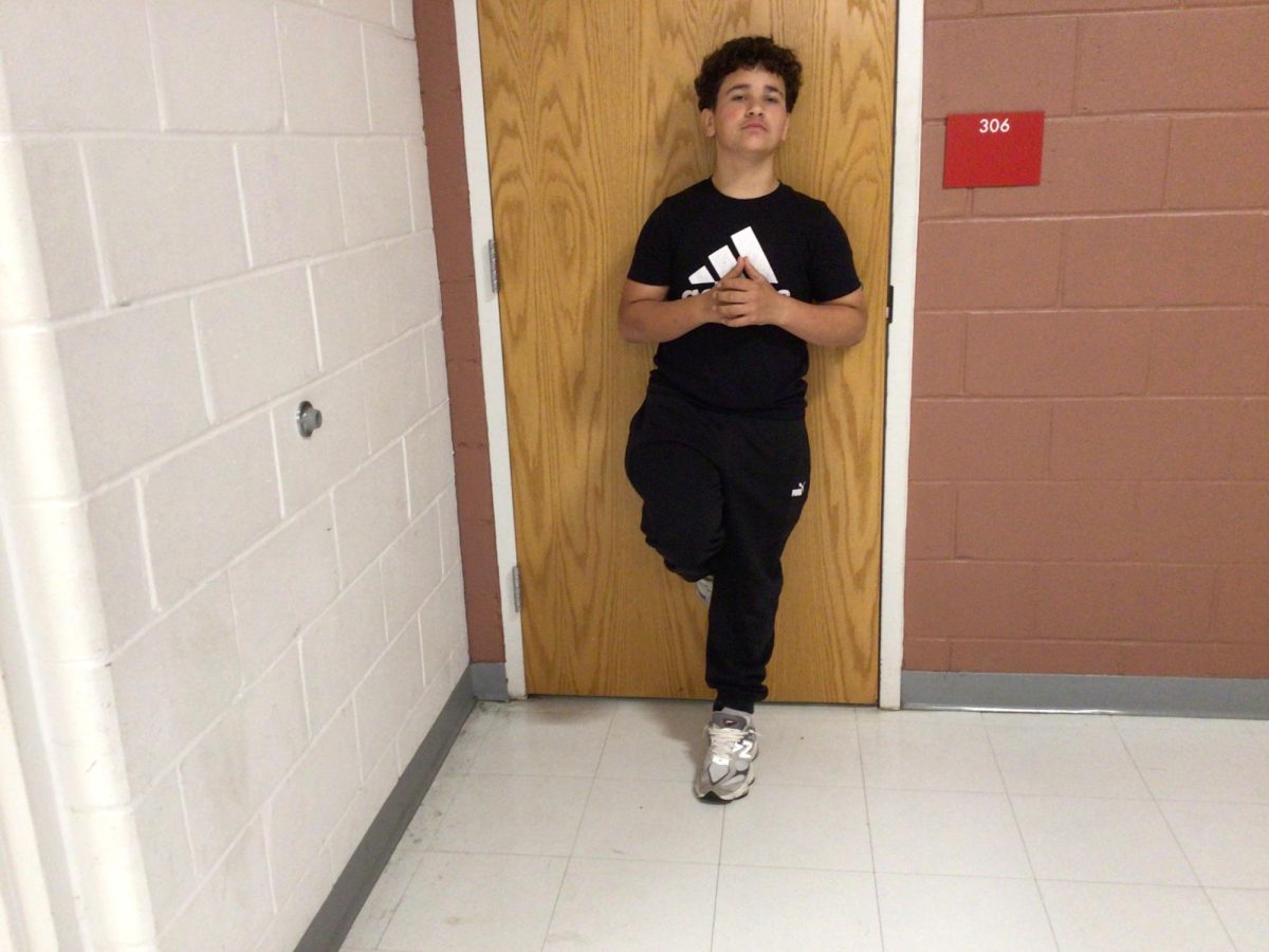 Jacob Flores poses for photo in front of room 307