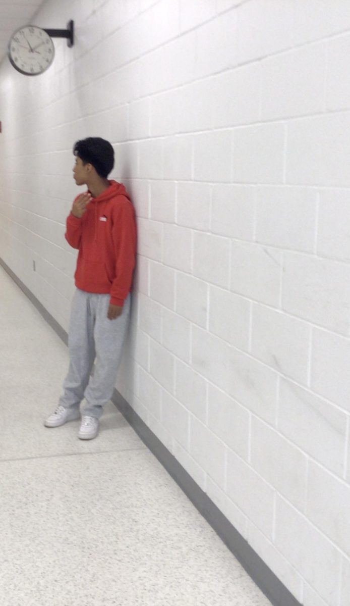 Brandon Camacena poses for photo in front of room 110