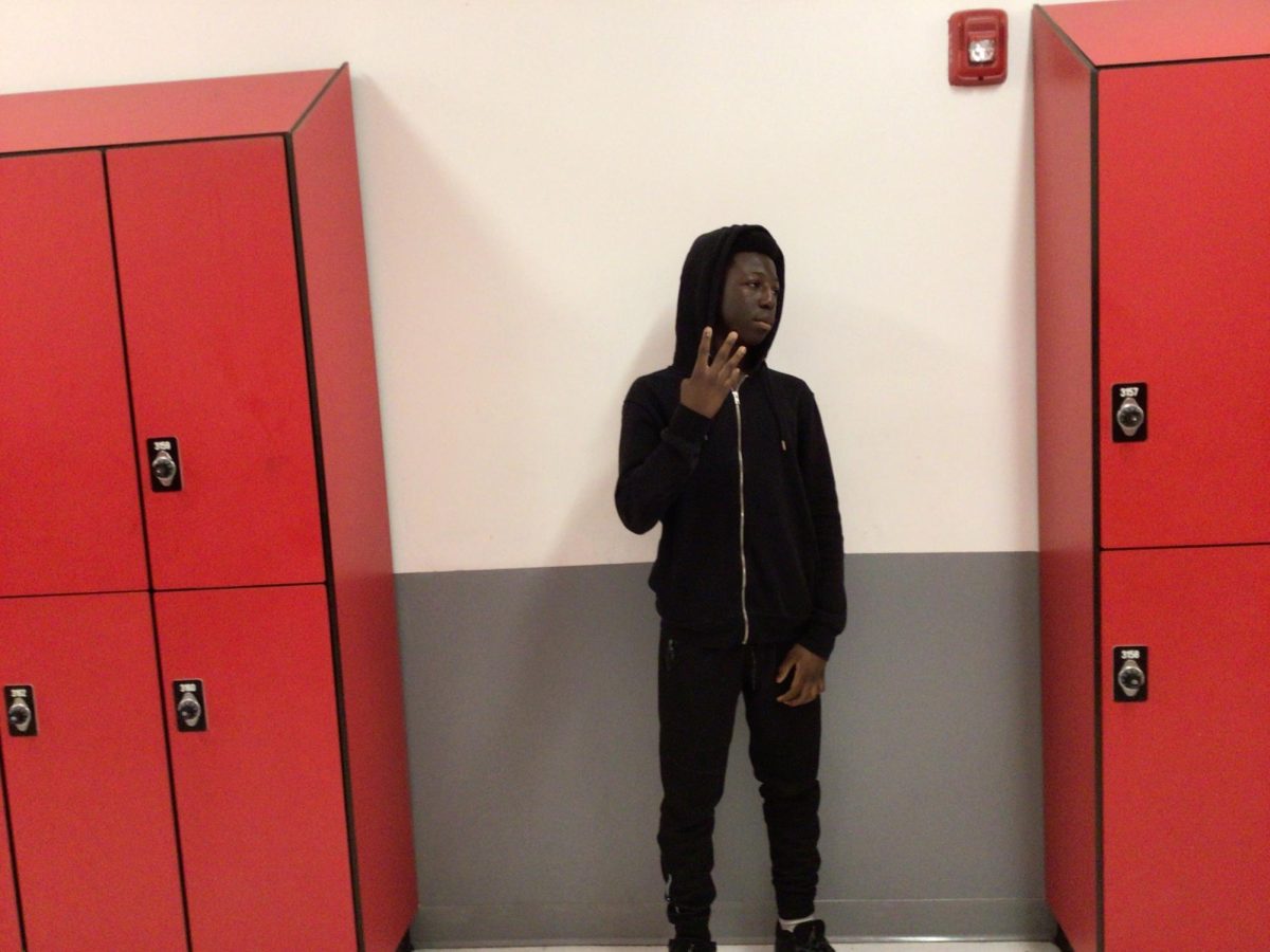 Elijah Richards poses for photo in front of computers room