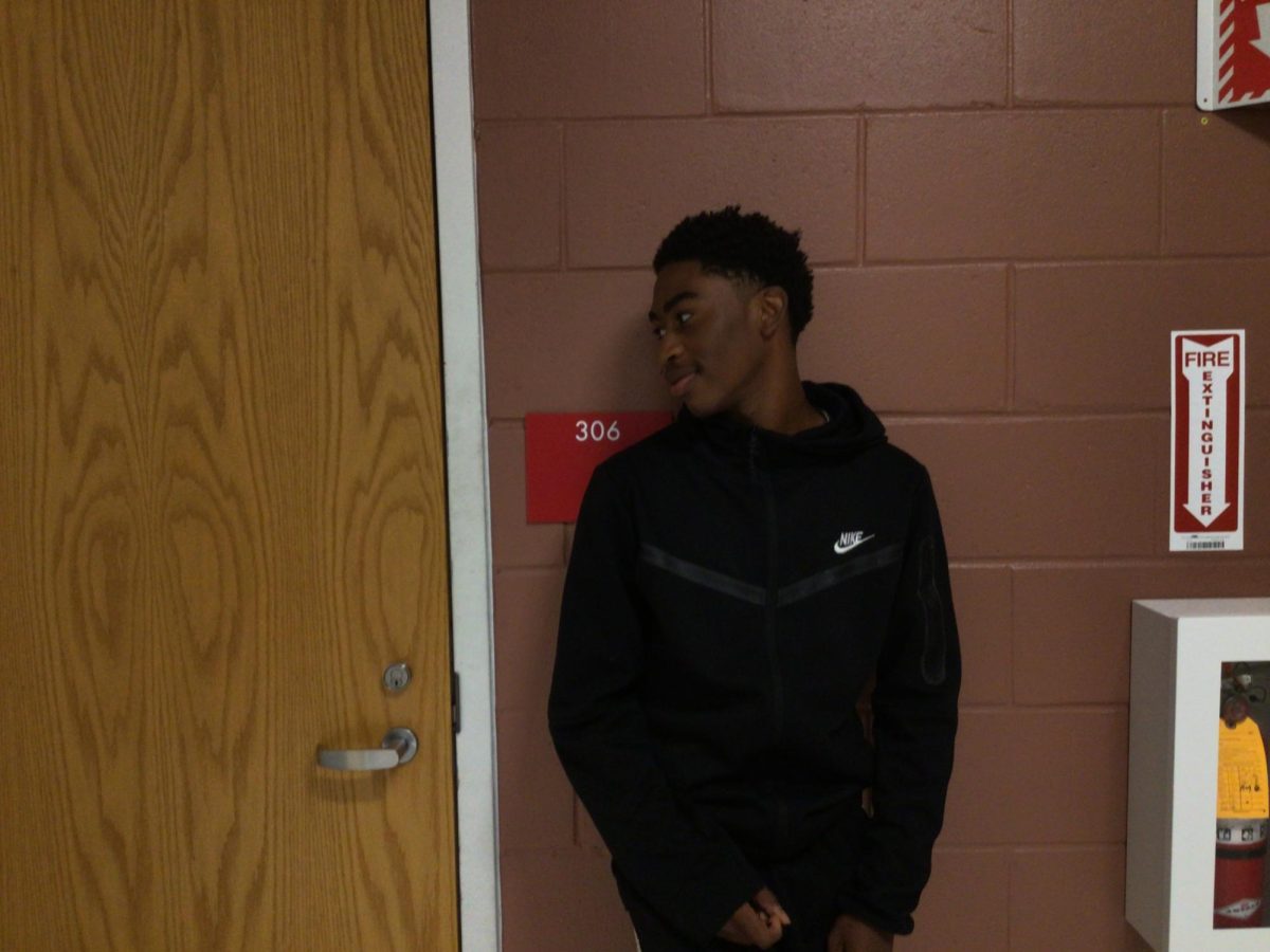 Jaylin Love Sneed poses for a picture outside of the Journalism Room at WMS