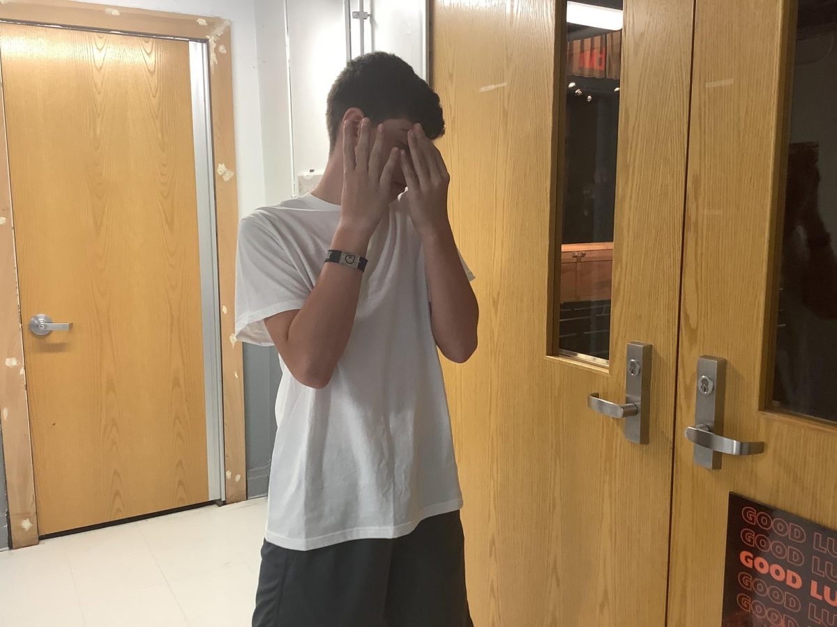 7th grader Braylen Sandklev poses in front of the auditorium doors on Monday at WMS.