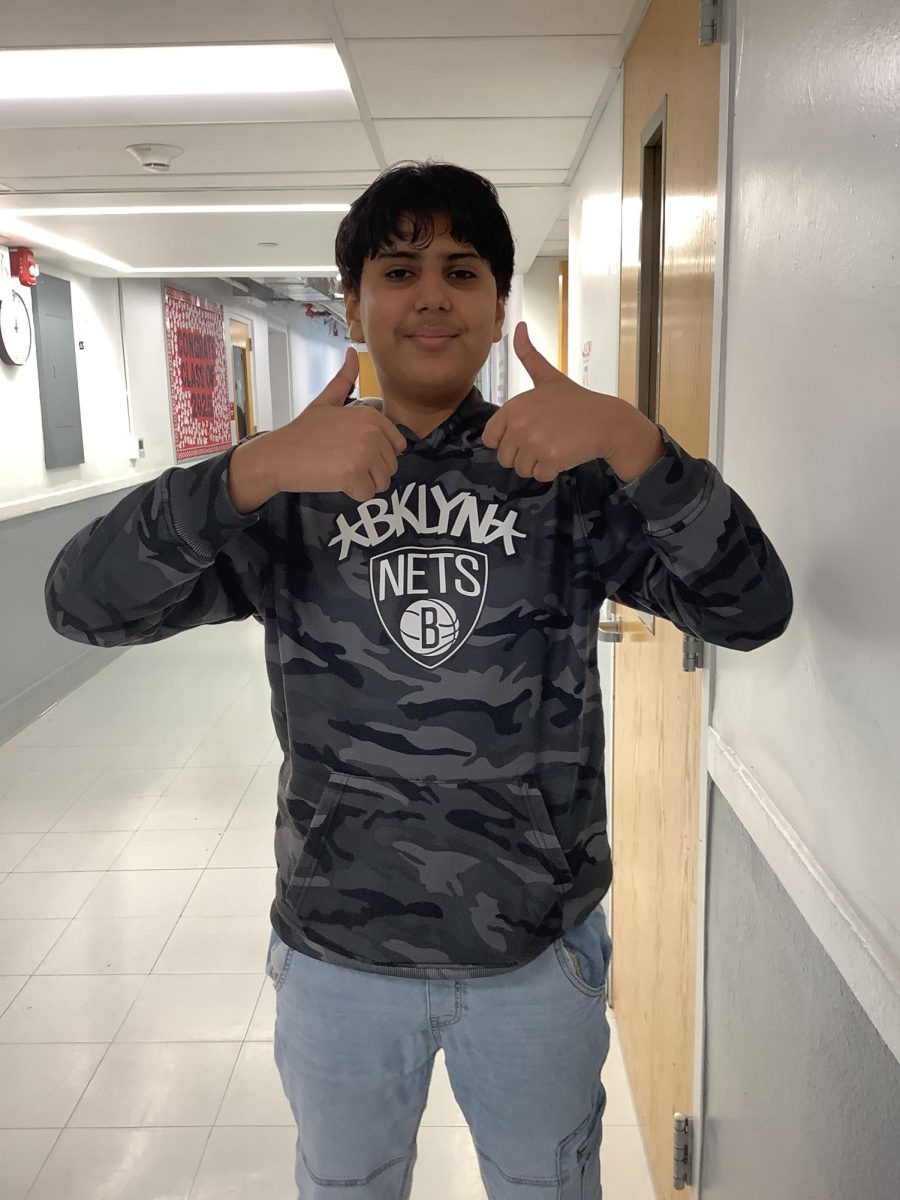 7th Grader Aayan Iqbal, poses in front of the door to the Health Classroom on Monday at WMS