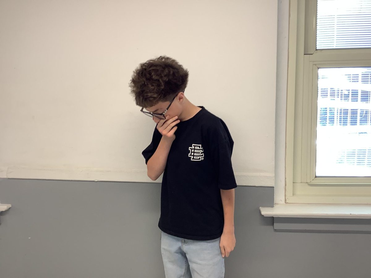 Blake Roe poses by a window in a hallway on the first floor on Tuesday at WMS