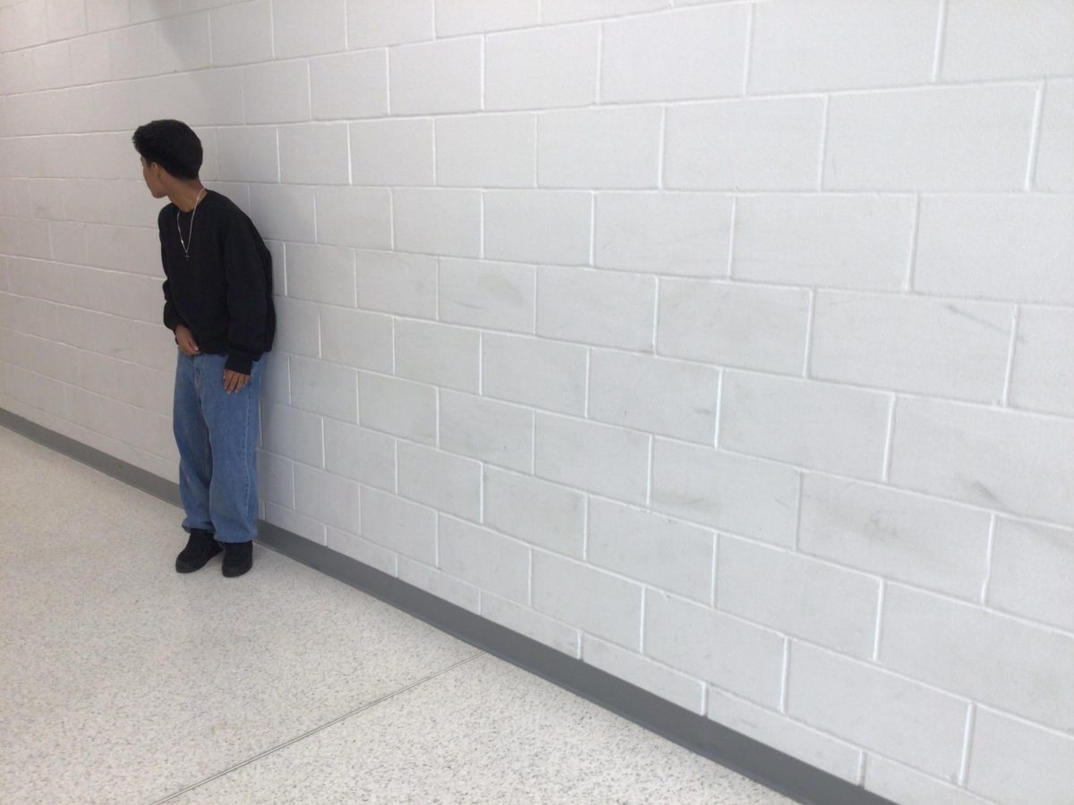 Brandon Camacena poses for photo in front of room 110