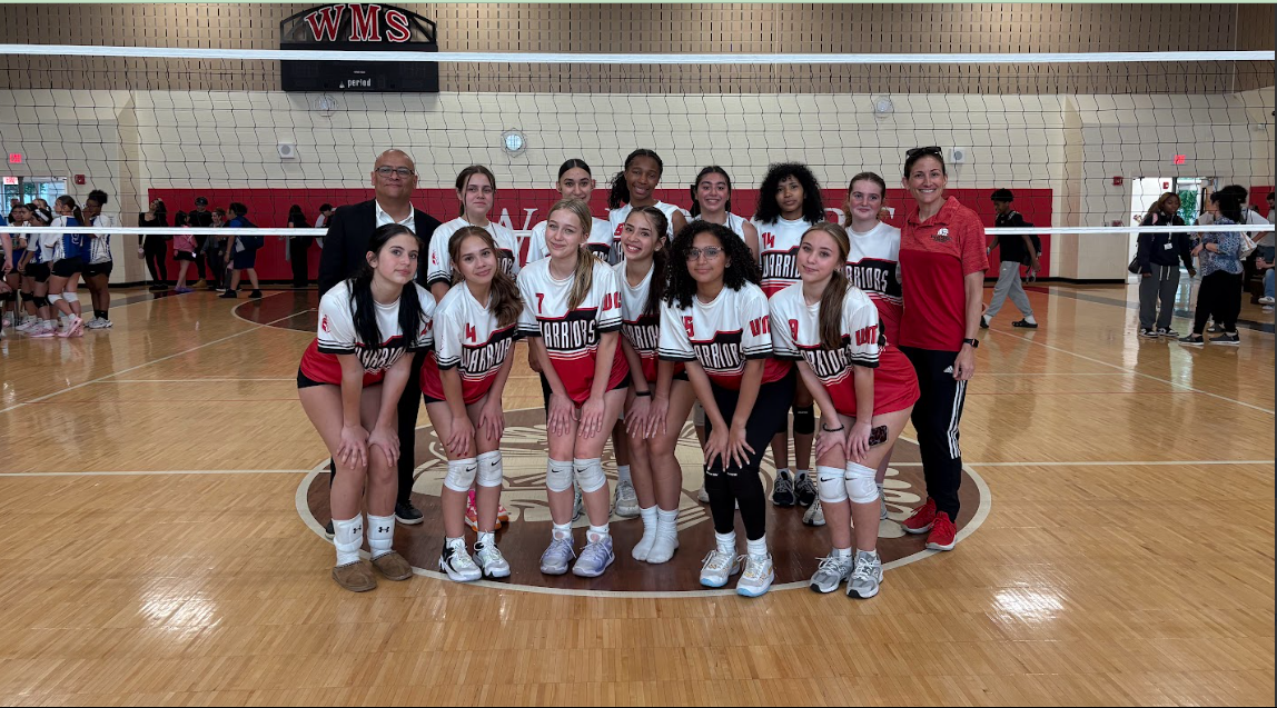 Girls volleyball team pose for a picture.