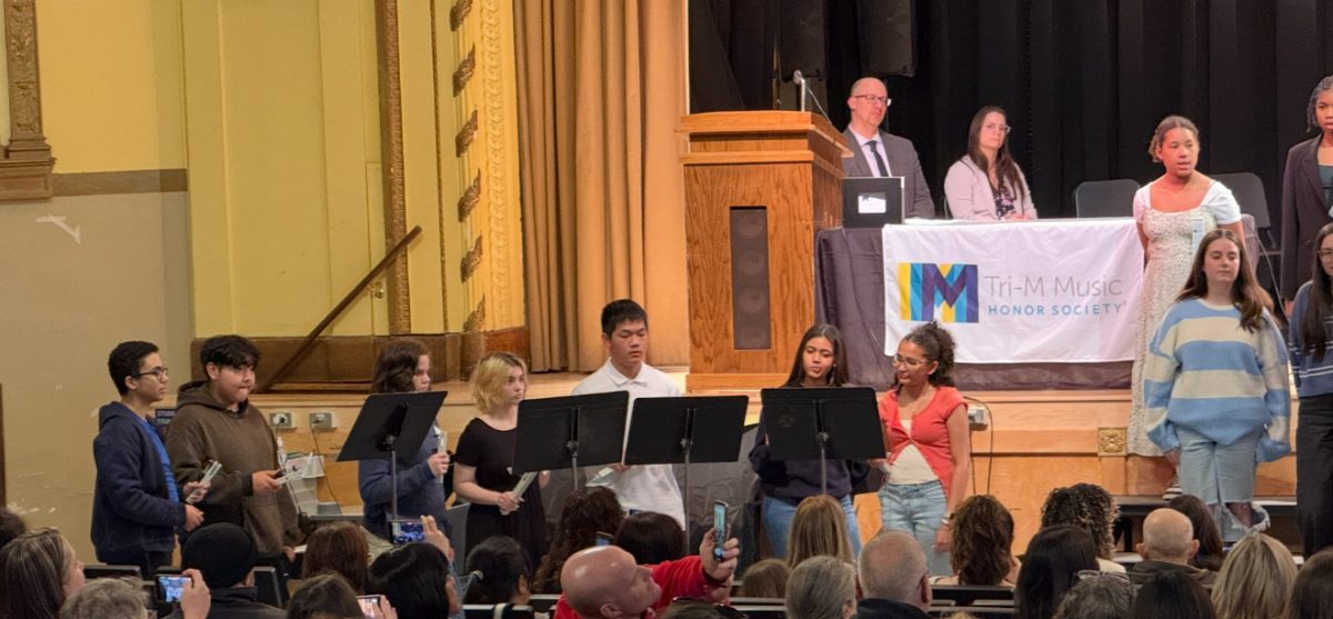 Students play the chimes at the 2025 Tri-M induction.