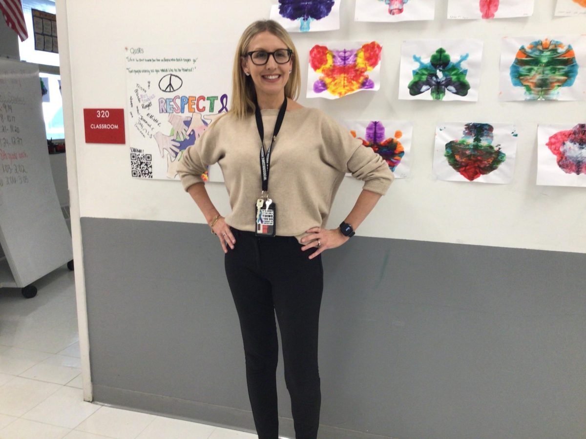 Mrs.Douglas, The cheer coach, poses for a picture at WMS.