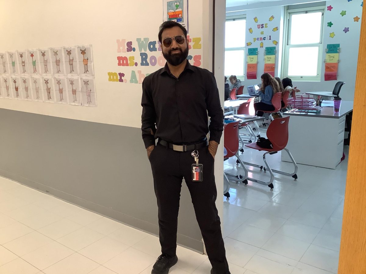 Mr.Ahmed poses for  a picture at  Woodbridge middle school.