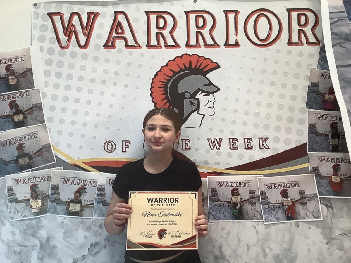 Nina poses with her Warrior of the Week poster