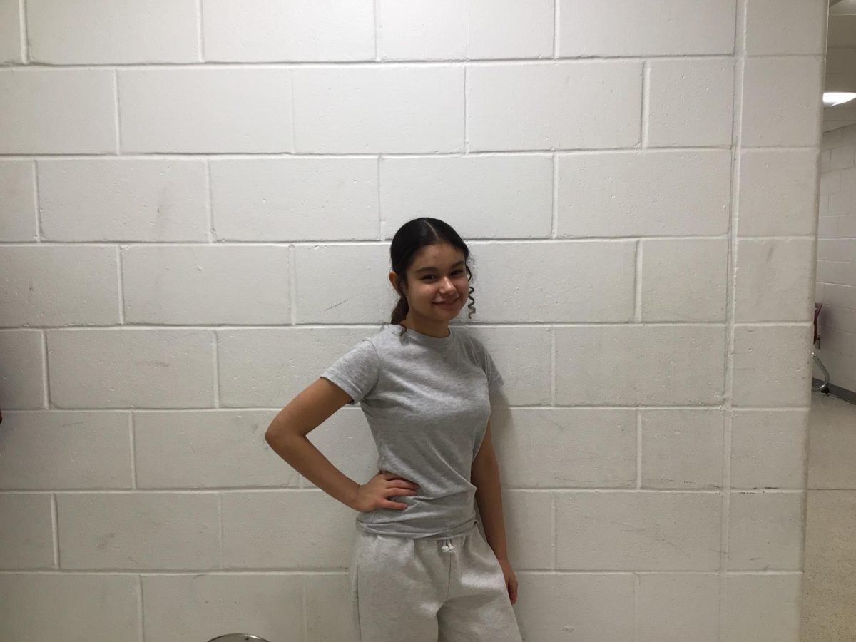 Olivia Sanchez stand's near the WMS art room