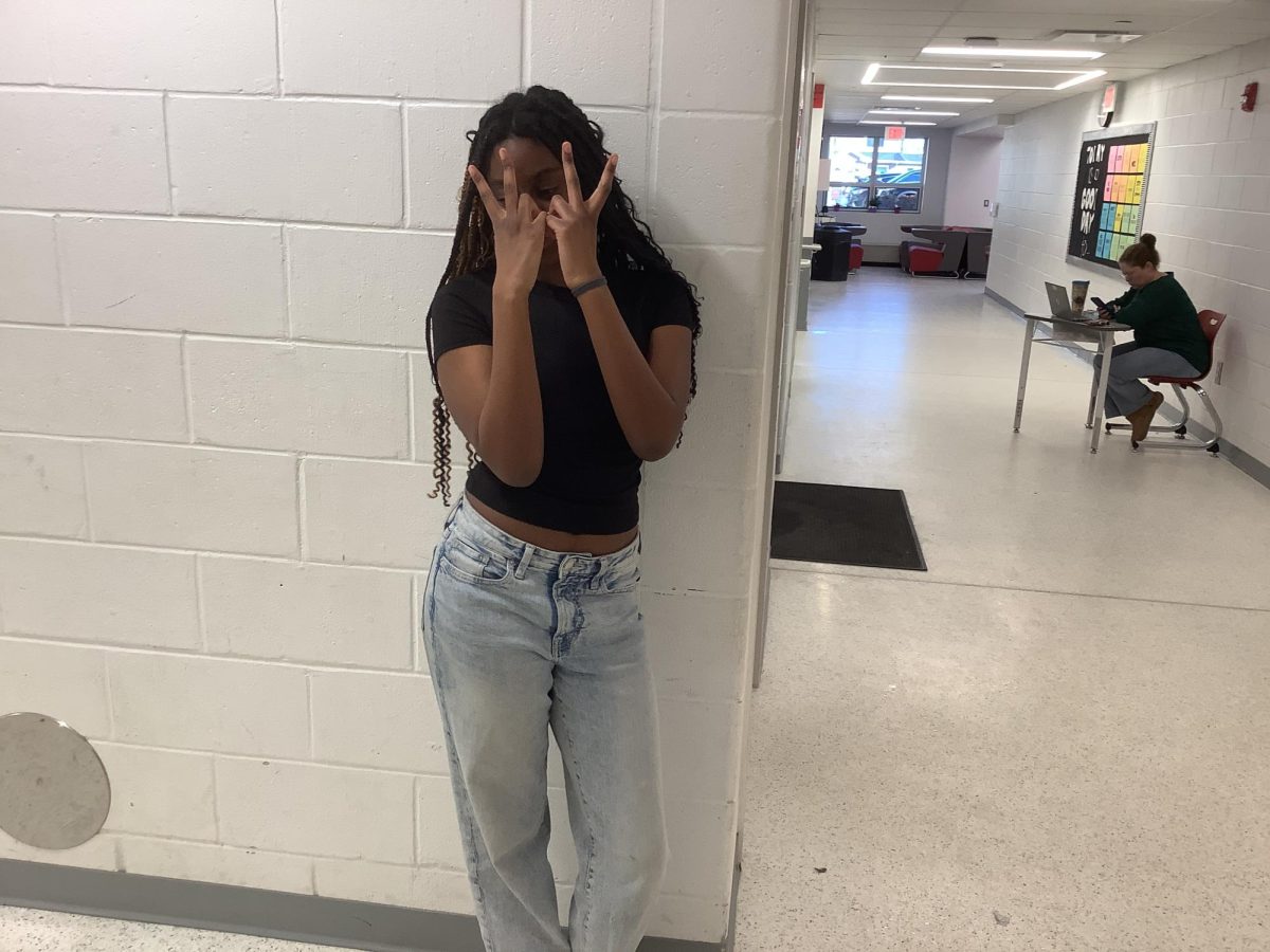 Jenna Innocent stands against a wall outside the gym