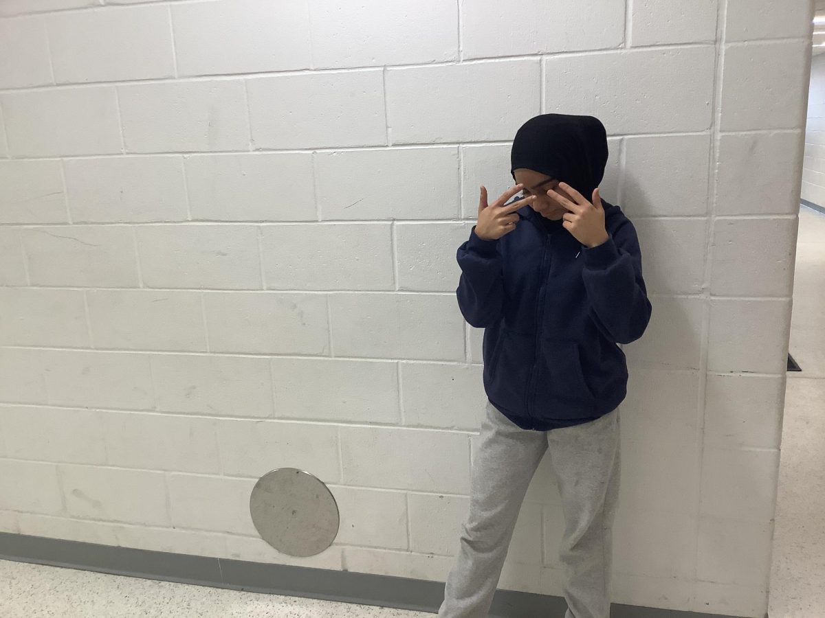 Nawal Sattar stands against the wall outside the WMS gym