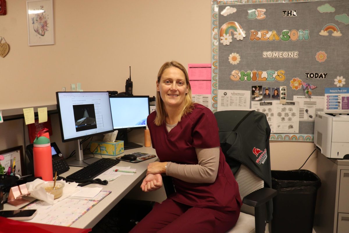 Nurse Tulli smiles for a picture while working