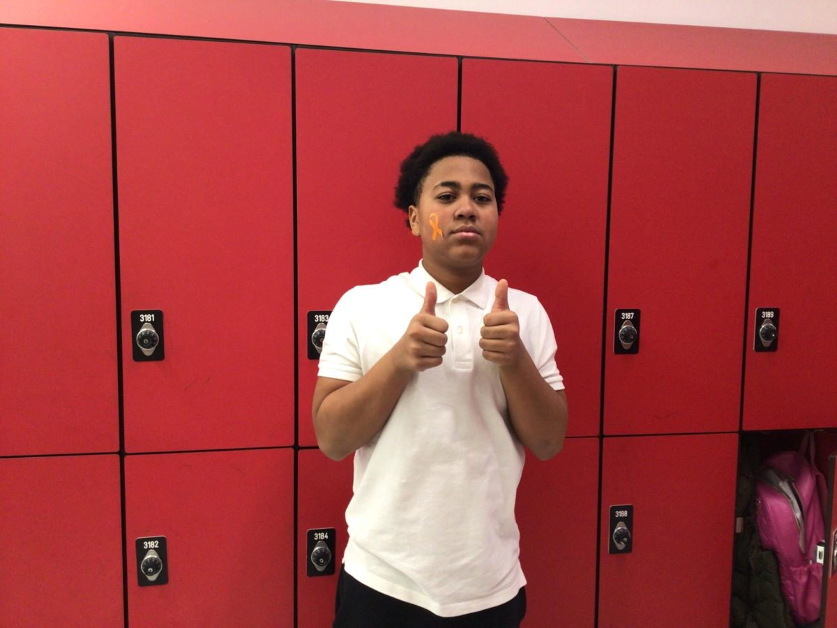 Kabeer Lewis poses for a photo outside the computer's room