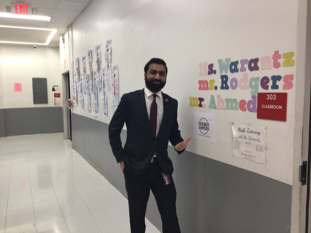 Mr. Ahmed poses for a photo in the WMS hallway.