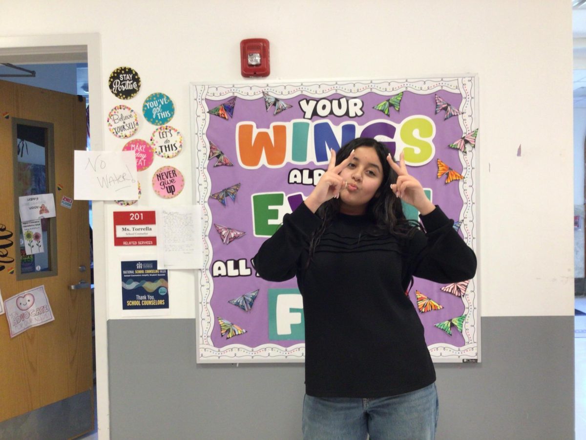 Israh Sukhera poses for a photo in the WMS hallway.
